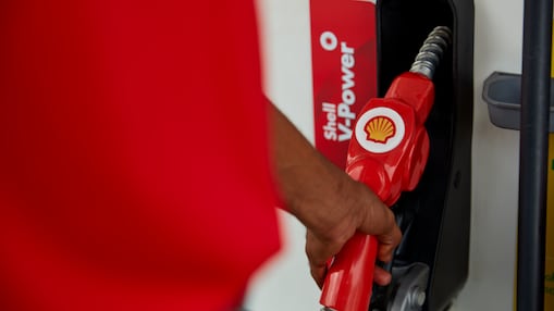 Person filling vehicle with fuel