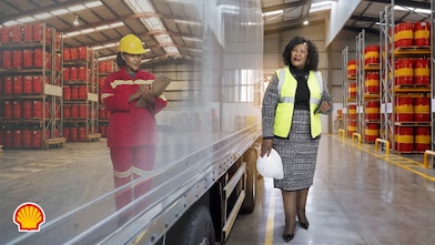 Shell campaign image depicting business growth and entrepreneurship. The left side shows a warehouse worker using a clipboard in a storage facility with shelves stocked with products. The right side shows a business professional walking through a modern warehouse with industrial storage racks and inventory drums. The image represents the progression and support of businesses over time. Campaign text reads: “Over 120 years & we are still here for Mzansi entrepreneurs. You can ALWAYS COUNT on us.” Shell branding appears in the bottom left corner.