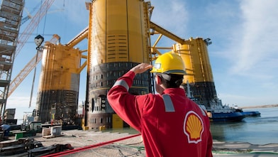 Engineer looking up at platform under construction