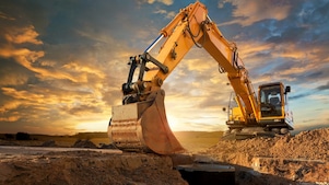 An excavator making trenches on a construction site