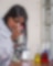 Female laboratory technician testing different samples of fuel under a microscope