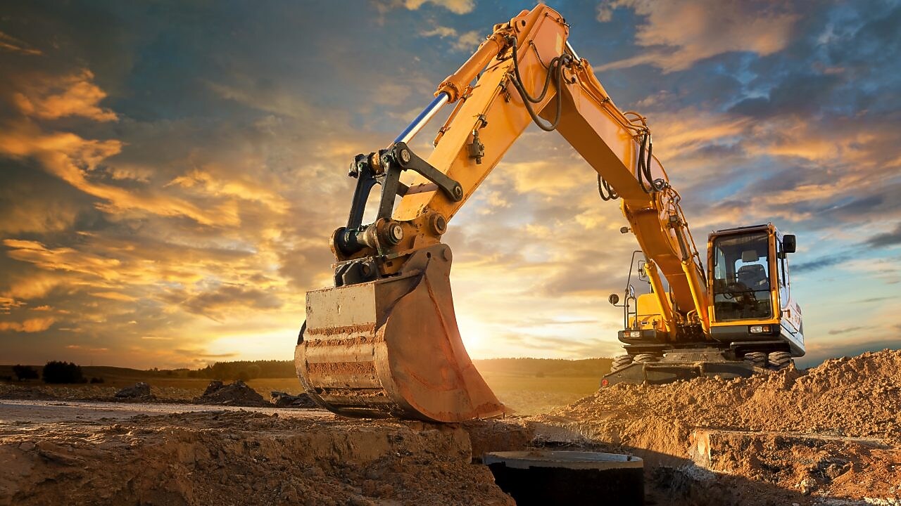 An excavator making trenches on a construction site