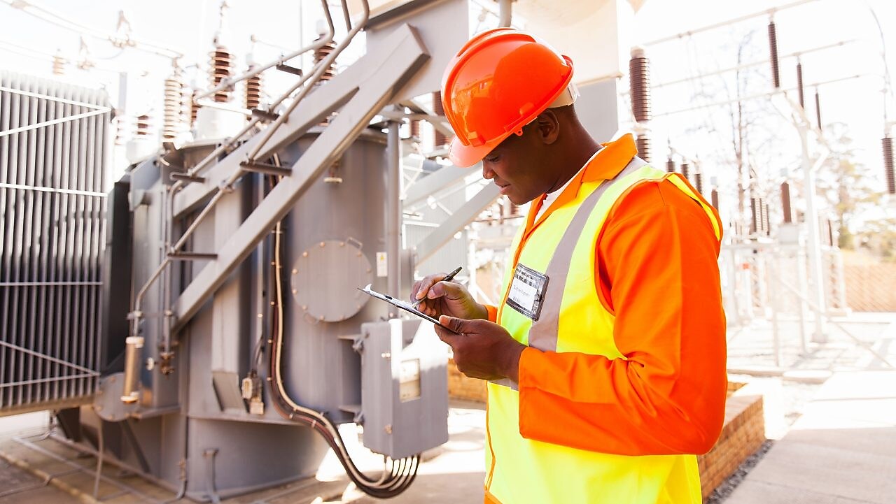 Man carrying out safety checks at a fuel distribution site in South Africa