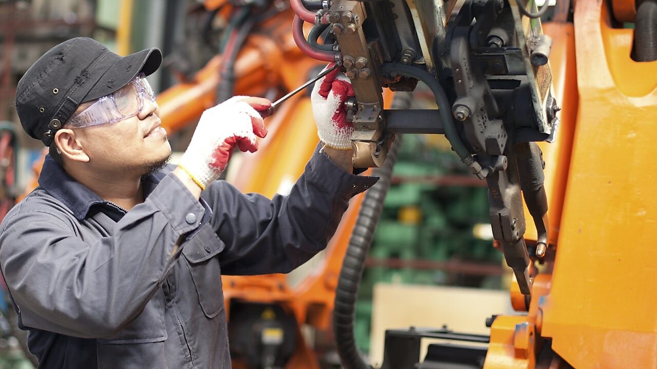 Male technician fixing an engine