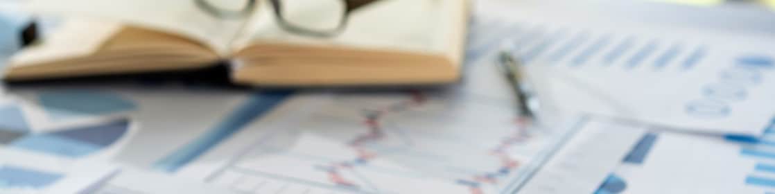 Different line graphs showing trends next to a calculator