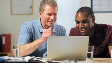 Male colleagues looking on a computer screen