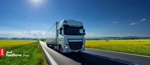 Lorry driving on a road next to a rapeseed field