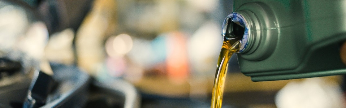 A close up on a lubricant pouring from a bottle