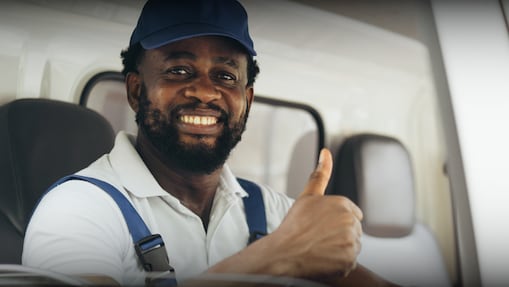 Truck Driver in a blue hat giving a thumbs up