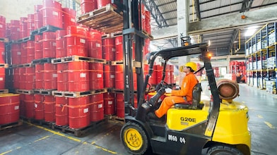 man working barrels lubricants