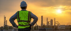 Man standing in front of Petrochemical refinery
