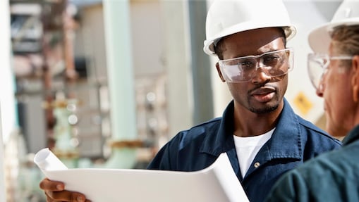 Industrial workers reviewing plans