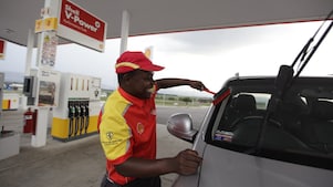 Man smiling while washing car windshield
