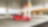 A red Ferrari sitting on a Shell station forecourt with a man leaning on a petrol pump