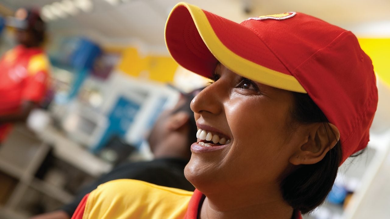 Smiling Shell select employee wearing red cap