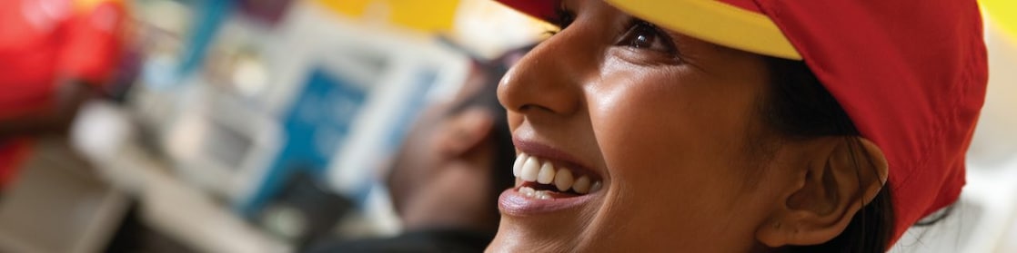 Smiling Shell select employee wearing red cap
