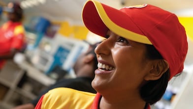 Smiling Shell select employee wearing red cap