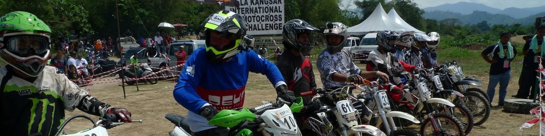 Motorcross motorcycles lining up at the start of a race