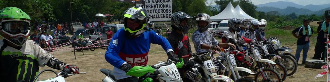Motorcross motorcycles lining up at the start of a race