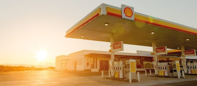 Sun rising behind a Shell station forecourt